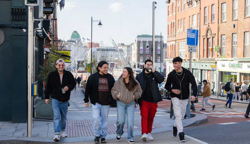 five walkers crossing a street junction in Cork city - Walking and Cycling Index