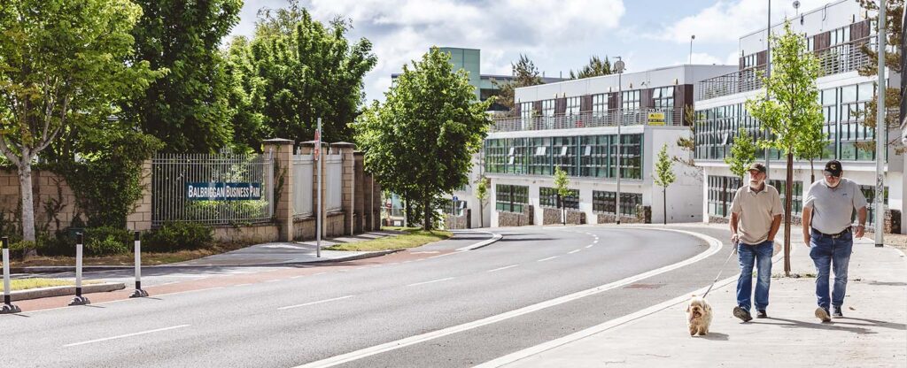 men walking with a dog in Dublin 1600x650