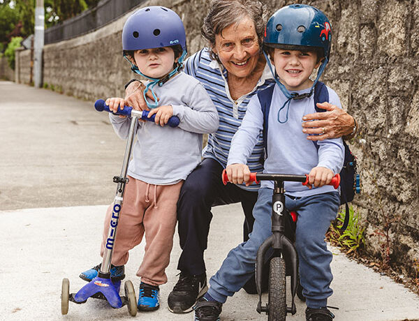 parent with two children on scooter and bike Dublin