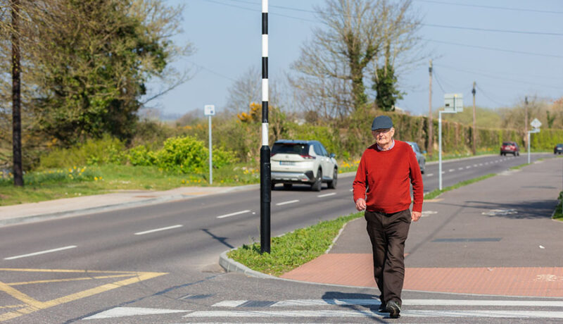 pedestrian male crossing road at zebra crossing junction Cork