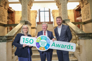 Minister of State S&eacute;an Canney presents the 150th Smarter Travel Mark to the National Library of Ireland (NLI) Dr. Audrey Whitty, with John O'Flynn NTA