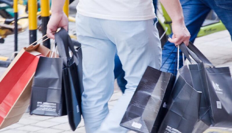 Person carrying shopping bags - shopping banner 1600x700